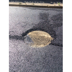 Protection for Asphalt-Coated Manhole Cover